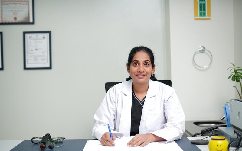 Dr. Sravanthi at her desk in the clinic